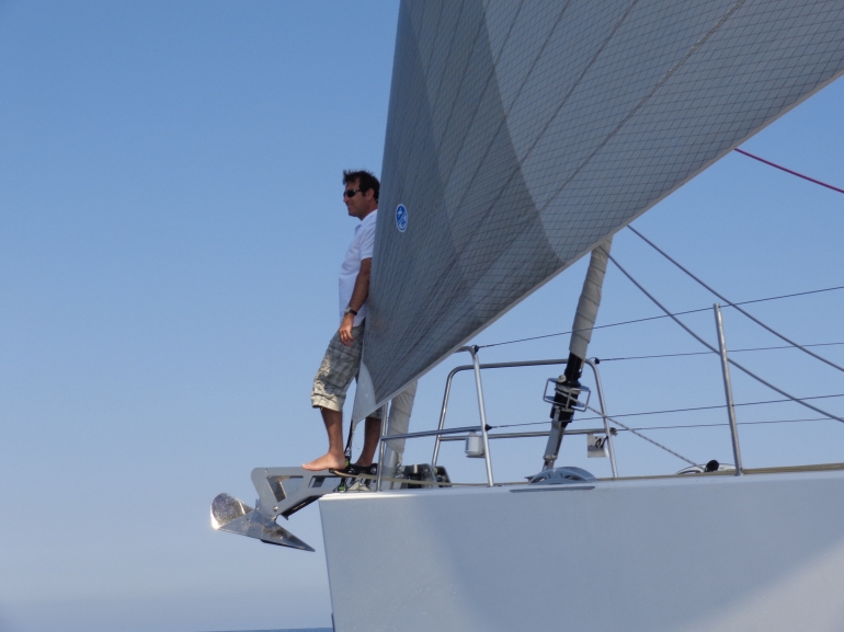 Jeanneau's Nick Harvey enjoys a spot on the bow of the 64 just in front of the Code 0