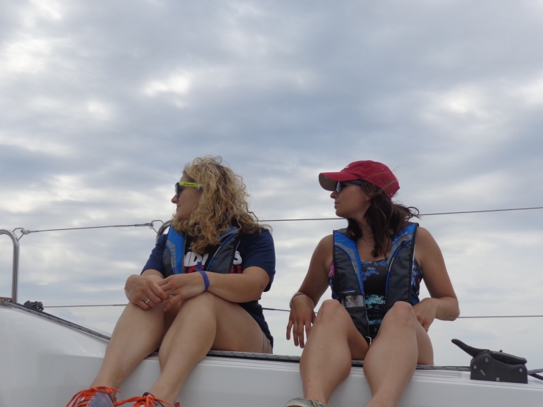 Olivia and Victoria Robertson hang on the rail aboard the Jeanneau 349